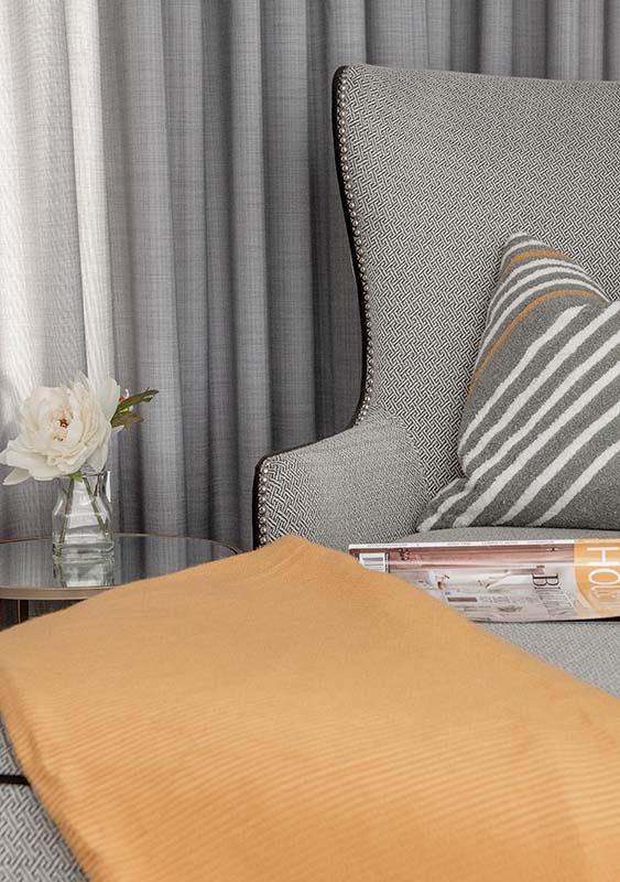 detail of cosy chair with blanket and magazine