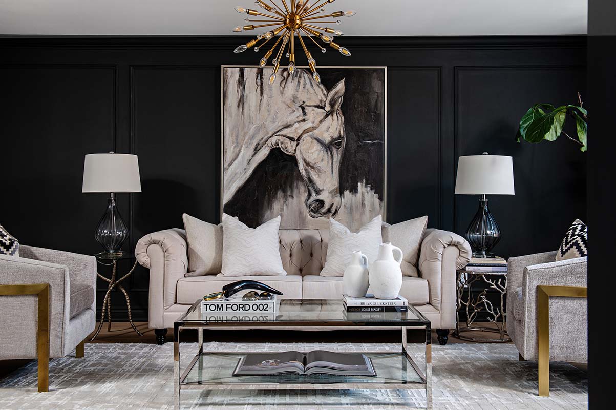 painting of a horse, counch, coffee table and chairs